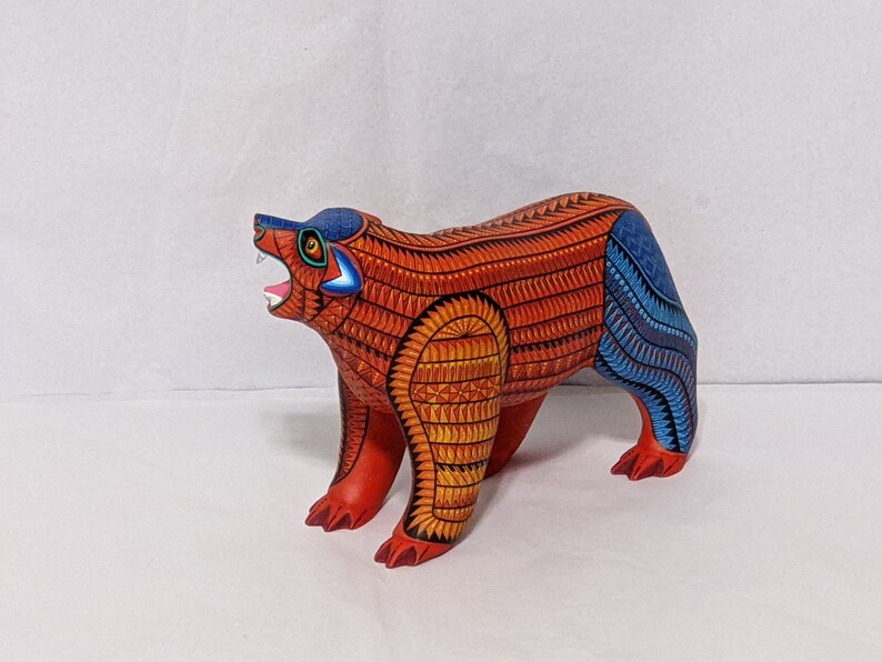 5.5 Inches in Height Original Handmade, Hand Painted Animal, Wood Carving with Irate Eyes, Copper Colored Tail, Colorful Patterned Body, Blue Colored Hind legs, Bear Alebrije, Oaxaca Art, Unique Statue from https://luv2brd.etsy.com