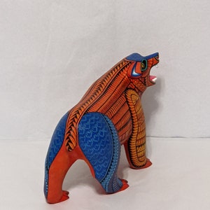 5.5 Inches in Height Original Handmade, Hand Painted Animal, Wood Carving with Irate Eyes, Copper Colored Tail, Colorful Patterned Body, Blue Colored Hind legs, Bear Alebrije, Oaxaca Art, Unique Statue from https://luv2brd.etsy.com