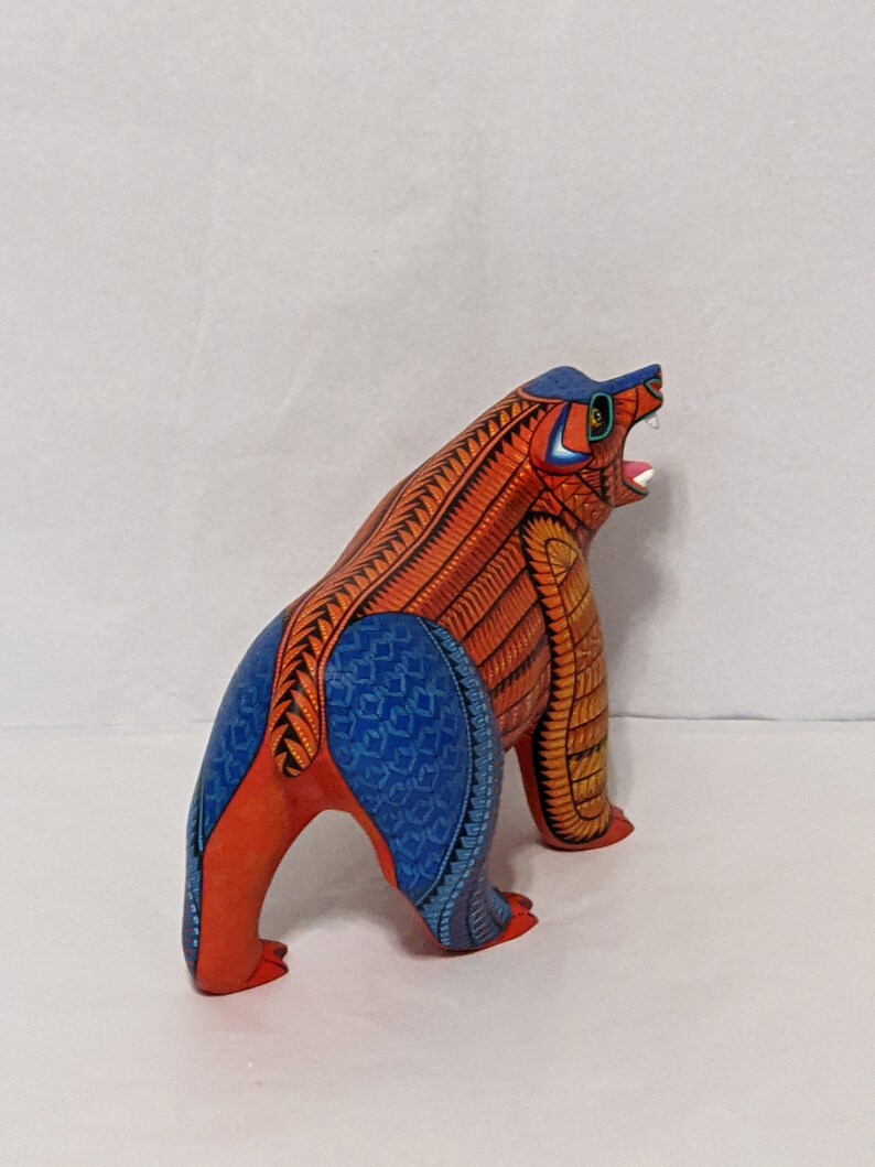5.5 Inches in Height Original Handmade, Hand Painted Animal, Wood Carving with Irate Eyes, Copper Colored Tail, Colorful Patterned Body, Blue Colored Hind legs, Bear Alebrije, Oaxaca Art, Unique Statue from https://luv2brd.etsy.com