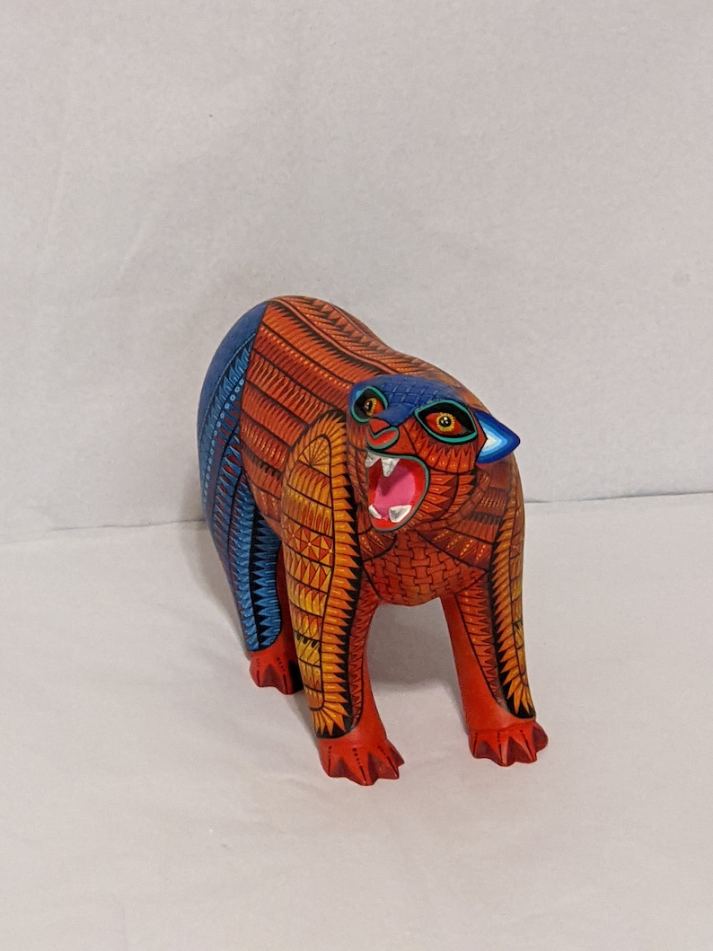 5.5 Inches in Height Original Handmade, Hand Painted Animal, Wood Carving with Irate Eyes, Copper Colored Tail, Colorful Patterned Body, Blue Colored Hind legs, Bear Alebrije, Oaxaca Art, Unique Statue from https://luv2brd.etsy.com