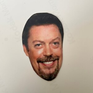 May include: A cut-out image of a smiling man with dark hair and a neatly trimmed beard. The man has fair skin and is smiling, revealing his teeth. The image is on a white background.