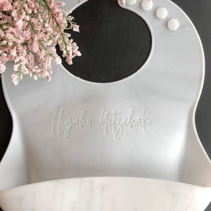 Custom Marble Baby Bib with First and Last name Laser engraved on a black background with flowers