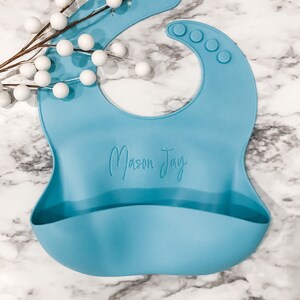 Personalized Blue Toddler Bib for Baby Led Weaning with Name Laser engraved on Marble Background