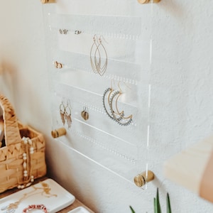 Modern Clear Acrylic Earring Storage with Stud and Dangling Earrings on display above a desk with house plant