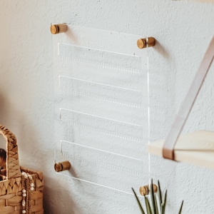 Modern Clear Acrylic Earring Storage with Stud and Dangling Earrings on display above a desk with house plant