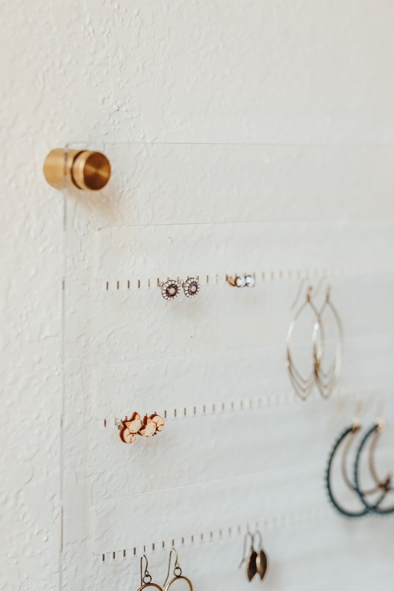 Modern Clear Acrylic Earring Storage with Stud and Dangling Earrings on display above a desk with house plant