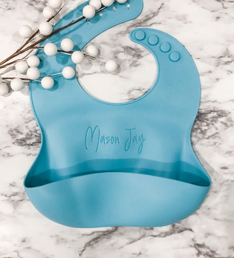 Personalized Blue Toddler Bib for Baby Led Weaning with Name Laser engraved on Marble Background