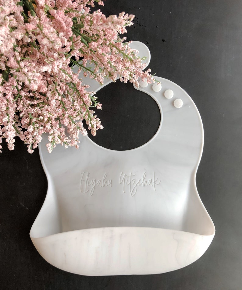 Custom Marble Baby Bib with First and Last name Laser engraved on a black background with flowers