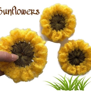 May include: Three yellow crocheted sunflowers with brown centers. The sunflowers are arranged in a triangular pattern on a white background. The word "Sunflowers" is written in brown text at the top of the image.