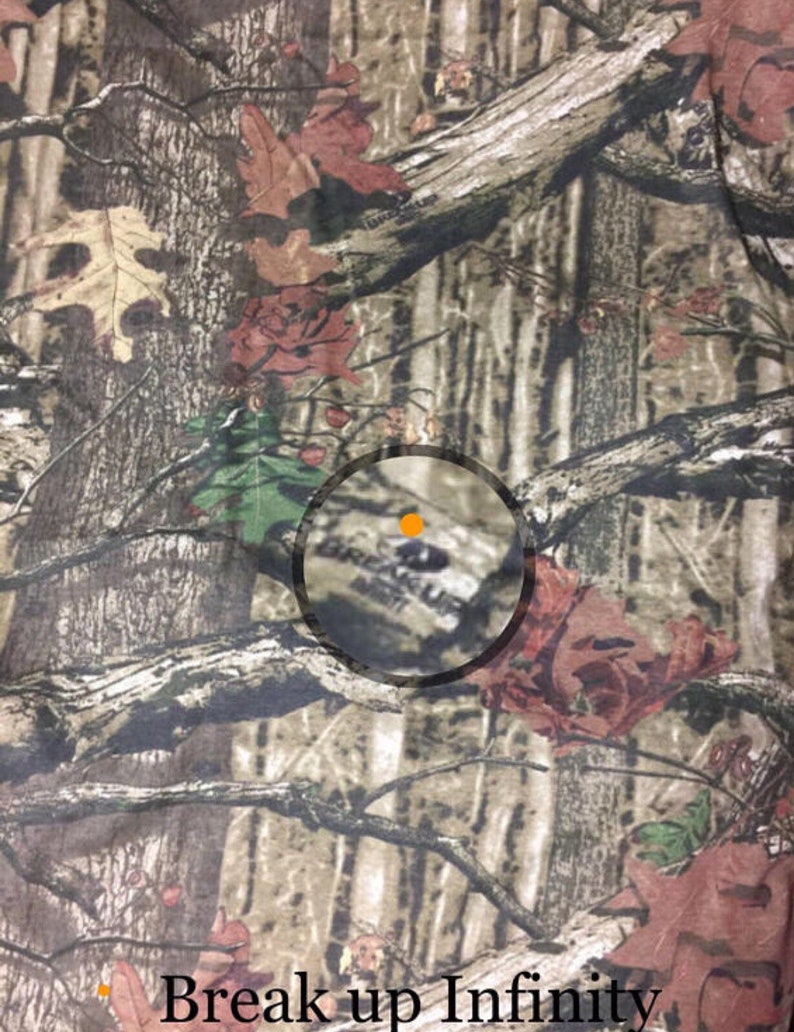 May include: Camouflage fabric with a brown, green, and red pattern. The fabric has a circular logo with the text "Break Up Infinity" in the center.