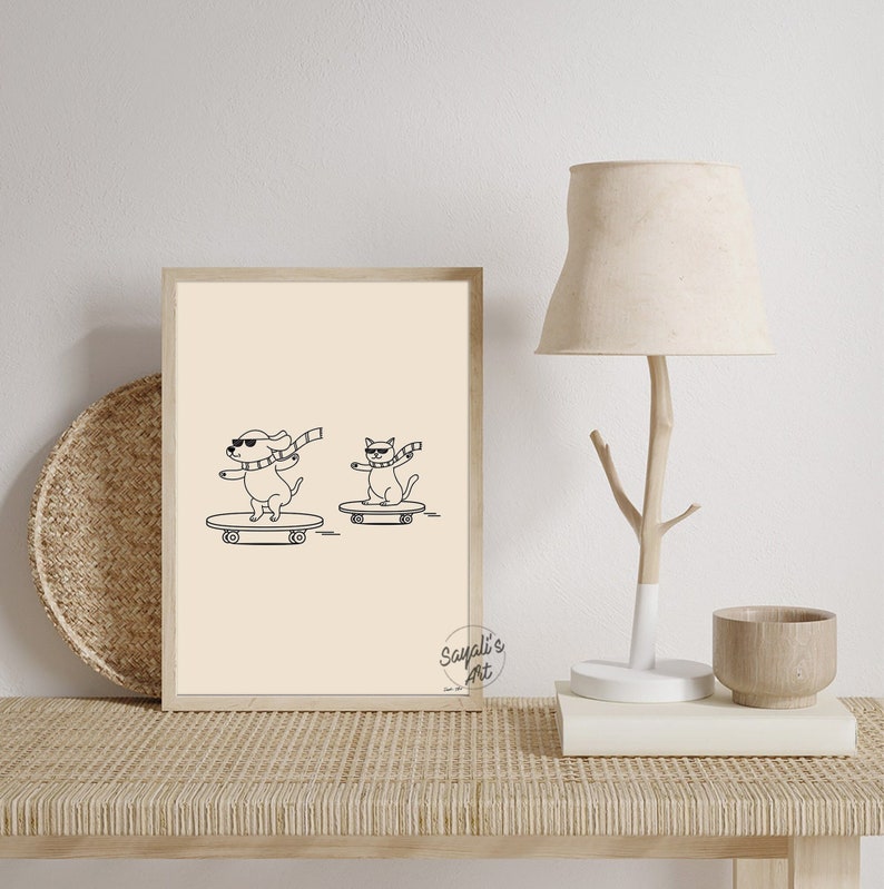 May include: A black and white line drawing of a dog and a cat wearing sunglasses and scarves, skateboarding. The image is on a cream background with the text "Sayali's Art" in the bottom right corner.