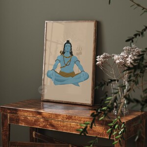 May include: A framed wall art print featuring a blue-skinned figure in a meditative lotus position. The figure wears a golden snake around the neck, a brown waist cloth, and has a trident symbol in the background with a light halo effect.