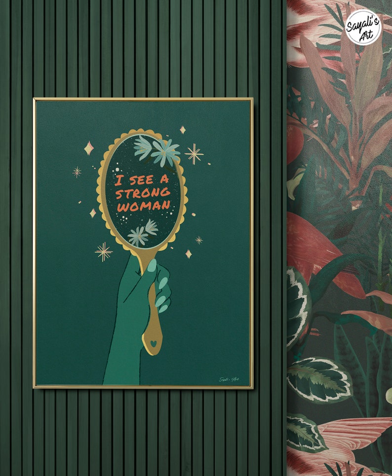 artwork of a quote "i see a strong woman" is written on a mirror held by a woman hand, this artwork is in emerald green in color .it is a vertical poster