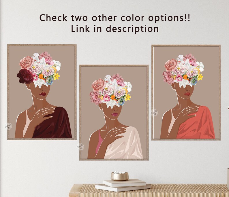 May include: Three framed illustrations of a woman with a floral crown covering her face. The woman in the left frame is wearing a burgundy dress, the woman in the centre frame is wearing a light pink dress, and the woman in the right frame is wearing a coral dress. The background of each frame is a light brown colour.