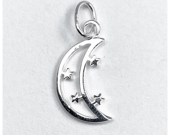 May include: A silver pendant featuring a crescent moon design with three stars. The pendant has a loop for a chain. The design is simple and elegant, suitable for jewellery.