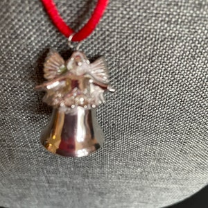 Silver Tone Angel Bell Christmas Necklace on red cord