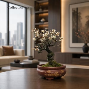 May include: A bonsai tree with dark, textured bark and small white blossoms, planted in a round, reddish-brown ceramic pot featuring gold-painted landscape motifs. The base of the tree is covered in green moss, and the text CollectorPets is visible.