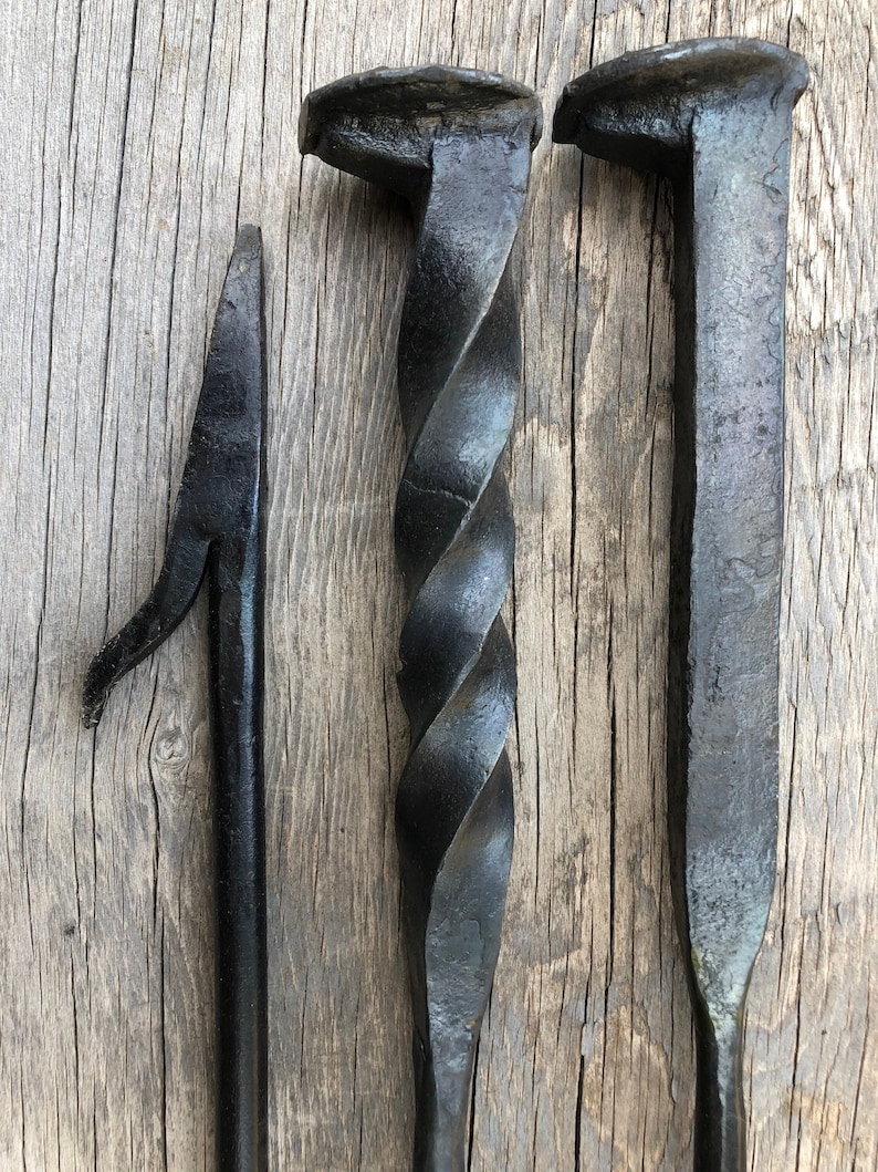 All metal hand forged fire poker. Made from a railraod spike handle welded to a hand forged fire poker. Three different style: straight, twisted and stairstep. Twisted and straight handles pictured here with the fire poker end.