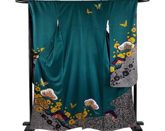 May include: A teal kimono with a black stand. The kimono features a floral and butterfly design in yellow, white, and red. The bottom of the kimono has a gray and black wave pattern.