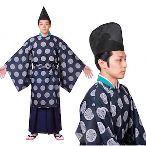 May include: A dark blue traditional Japanese garment featuring a repeating white circular floral pattern, wide sleeves, and a matching waist tie. The outfit includes solid dark blue pleated trousers, a black pointed headpiece, and sandals.