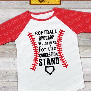 May include: White and red baseball-themed t-shirt with the text "Softball Brother I'm Just Here For The Concession Stand".