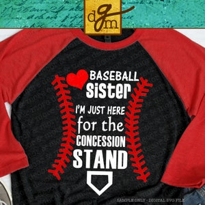 May include: A black and red baseball-themed t-shirt with the text "BASEBALL Sister I'M JUST HERE for the CONCESSION STAND" and a red heart. The shirt has a red sleeve and a black sleeve.
