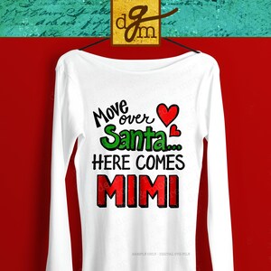 May include: White long-sleeved shirt with a red heart, green text that says "Move over Santa...", and black text that says "HERE COMES MIMI".