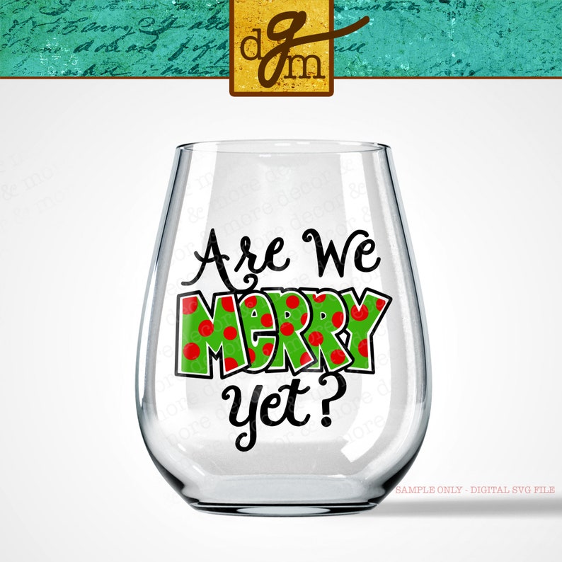May include: A clear glass wine glass with a green and red design that says "Are We Merry Yet?" on it.
