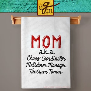 May include: White kitchen towel with red text that says "MOM a.k.a. Chaos Coordinator Meltdown Manager Tantrum Tamer".
