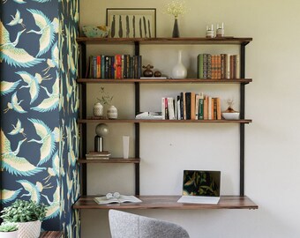 May include: A dark wood desk with a black metal frame and a floating shelf unit. The shelf unit has three shelves and is filled with books, decorative items, and a laptop. A gray chair sits in front of the desk.