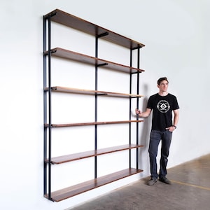 tall wall mounted bookshelf. Floating bookase hand-made with steel brackets and black walnut wood shelves. 6 shelf unit 7.5 ft high with bookend brackets