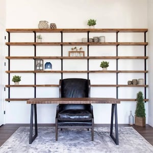 Floating Bookshelves perfect for organization and storage featuring 6 reclaimed pine shelves and sleek heavy duty steel brackets in a black poweder coated finish.