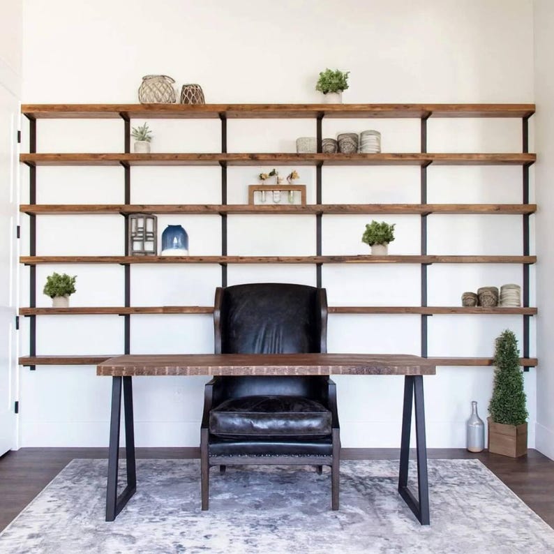 Floating Bookshelves perfect for organization and storage featuring 6 reclaimed pine shelves and sleek heavy duty steel brackets in a black poweder coated finish.