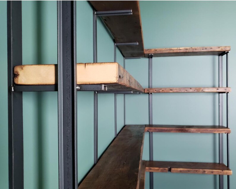 Solid steel shelf brackets with reclaimed wood floating bookshelf. Corner shelving unit