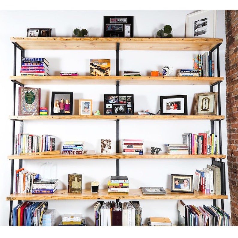 Tall office shelving unit made with solid reclaimed pine shelving and solid steel shelf brackets.