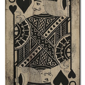 May include: A black and white illustration of the Jack of Spades playing card on a wood background. The card features a detailed design with a black suit and a stylized face.