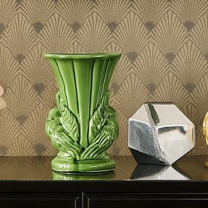 May include: A set of three ceramic mugs with a speckled, matte finish. The mugs are in shades of cream, light gray, and dark gray. Each mug has a simple, minimalist design, perfect for coffee or tea.