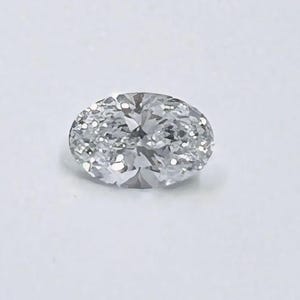 May include: A clear oval-shaped diamond gemstone with facets.