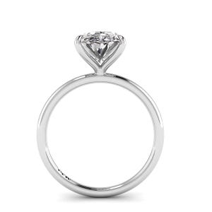 May include: A solitaire engagement ring with a round-cut diamond set in a sleek, polished silver band. The diamond is held by four prongs, showcasing its brilliance. The ring is designed with a minimalist aesthetic.