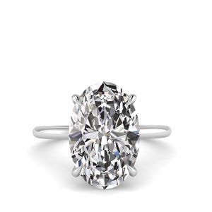 May include: A solitaire engagement ring featuring a large, oval-cut diamond. The diamond is set in a simple, thin, silver band. The gemstone sparkles with many facets, reflecting light. The ring is set against a white background.