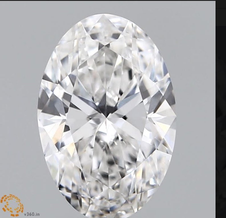May include: A large, clear, oval-shaped diamond with many facets.