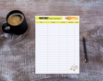 May include: A printable monthly bill tracker with columns for bill, amount, due date, paid date, and check. The tracker is on a wooden table with a cup of coffee and a pen.