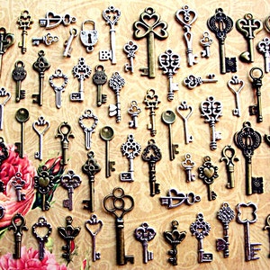 May include: A collection of antique keys in various sizes and designs, including skeleton keys, heart-shaped keys, and keys with ornate details. The keys are in shades of bronze, silver, and gold, arranged on a floral background.