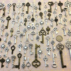 May include: A collection of antique-style keys in silver and bronze tones. The keys feature intricate designs and varying sizes, making them ideal for crafting or decorative purposes.