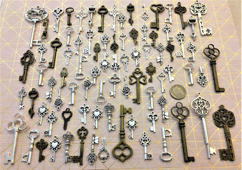 May include: A collection of antique-style keys in silver and bronze tones. The keys feature intricate designs and varying sizes, making them ideal for crafting or decorative purposes.