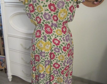 Vintage Day Dress (Size S 8'10) from the 1950's - Polyester lavender/pink/yellow floral print with cap sleeve and peplum
