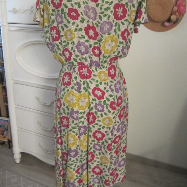 Vintage Day Dress (Size S 8'10) from the 1950's - Polyester lavender/pink/yellow floral print with cap sleeve and peplum