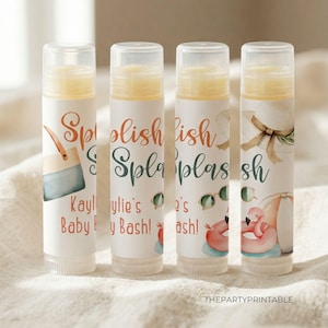 May include: Four lip balm tubes with clear caps. Each tube has a label with the words "Splish Splash" in orange and green script. The labels also feature beach-themed illustrations and the text "Kaylie's Baby Bash!"