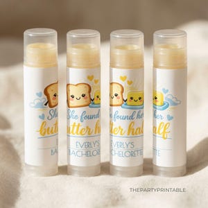 May include: Four lip balm tubes with white labels featuring a cartoon illustration of bread and butter. The text "She found her butter half" is printed on the labels, with "Everly's Bachelorette" below. The lip balms have clear caps.