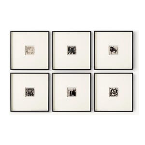 May include: Six framed black and white art prints. Each print features a small, abstract image within a white mat and a black frame. The prints are arranged in a grid pattern, showcasing a variety of artistic styles and compositions.